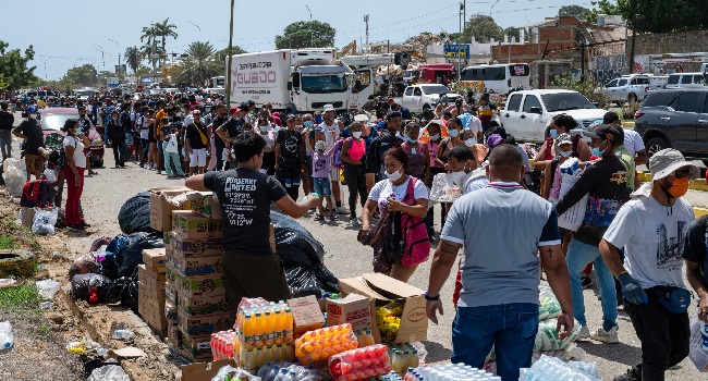 Following the earthquakes, residents stand in line to get donated food and beverages in Caraballeda, La Guaira, Venezuela, on June 27, 2026