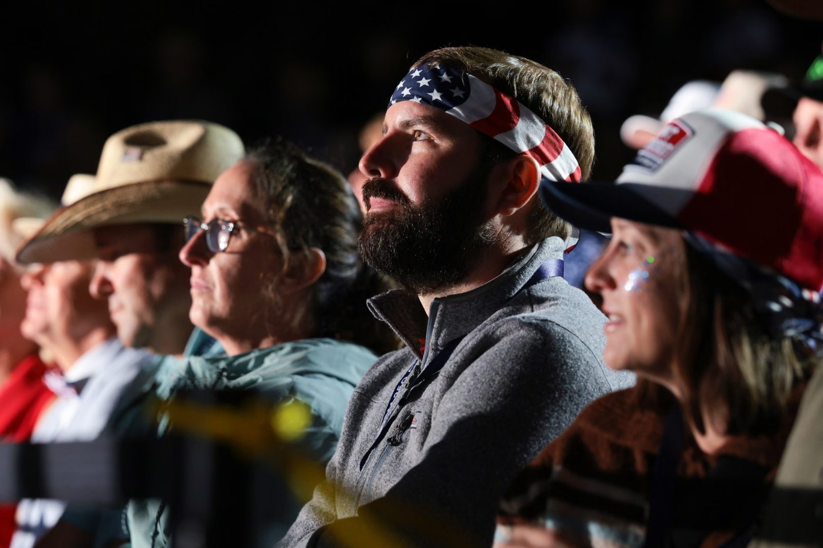 Supporters listen as Donald Trump speaks during a rally at Mount Rushmore